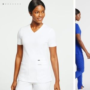 White Jaanuu Scrub Top size XS. Never worn still in packaging